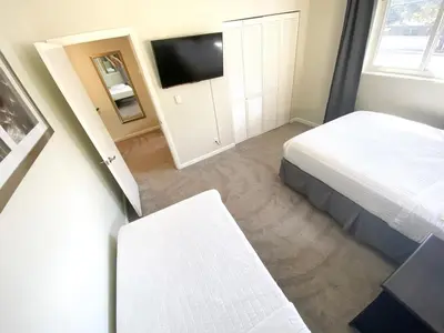 a bedroom with a bed and a television in it at Tarpon Harbor 1 - Waterfront pool home near beach & downtown Las Olas in Fort Lauderdale