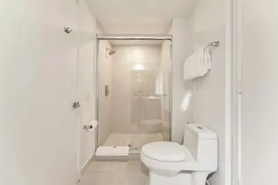 a white bathroom with a toilet and a shower at Spectacular Sunset Views Over the Ocean at Hollywood in Hollywood