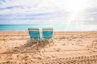 two chairs sitting in the sand on the beach at Sunny Miami Beach Retreat in Miami Beach