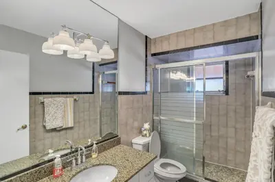a bathroom with a toilet and a sink and a shower at MiaBella of Hollywood home in Hollywood