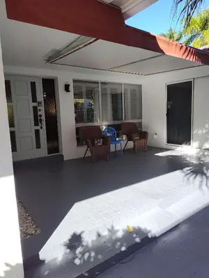 a house with a patio with chairs and a table at MiaBella of Hollywood home in Hollywood