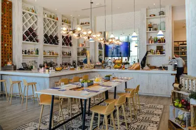 a restaurant with a long table and a bar at Gorgeous Views Await in Your Beachfront Condo in Hollywood