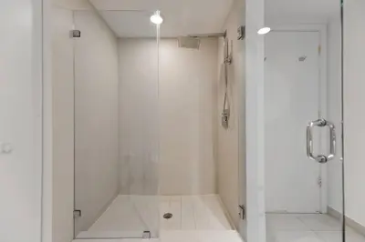 a bathroom with a shower with a glass door at Gorgeous Views Await in Your Beachfront Condo in Hollywood