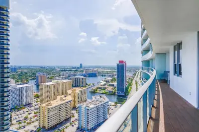 an apartment balcony with a view of a city at Luxury Condo with Oceanfront View in Hollywood in Hollywood