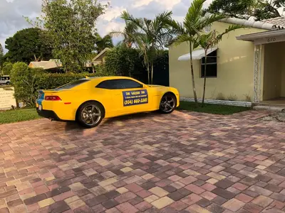 a yellow car parked in front of a house at Calypso Inn Wilton Gay Male Resort in Fort Lauderdale