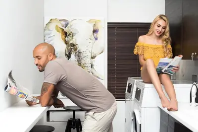 a man standing on a washing machine with a woman sitting on it at Vive Zen Queen Room in Miami