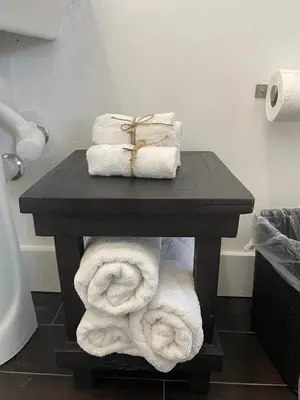 a table with towels and a box on top at Vive Zen Queen Room in Miami