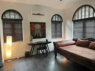 a bedroom with a bed and a table with a picture of an elephant at Vive Zen Queen Room in Miami