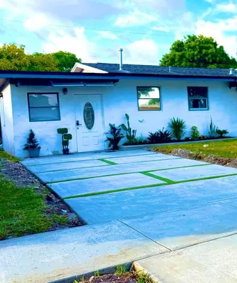 a white house with a driveway in front of it at Miami Gardens Comfort Suite by Hard Rock Stadium in Miami Gardens