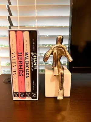 a small statue next to books on a desk at Modern Miami Oversized 3 Bedroom in Central Location in Miami