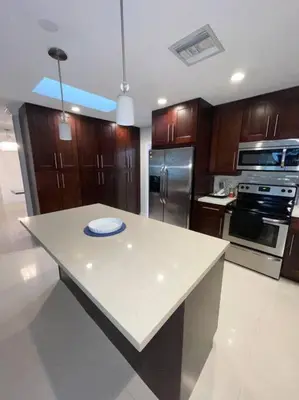 a kitchen with wooden cabinets and a white counter top at Modern Miami Oversized 3 Bedroom in Central Location in Miami