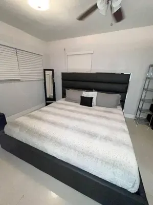 a bedroom with a large white bed with a ceiling fan at Modern Miami Oversized 3 Bedroom in Central Location in Miami