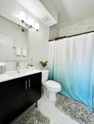a bathroom with a toilet and a sink and a shower at Modern Townhouse with terrace! in Homestead