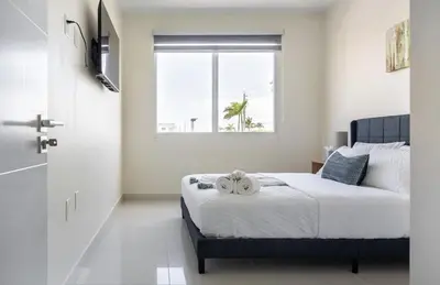 a bedroom with a bed with two towels on it at Modern Townhouse with terrace! in Homestead