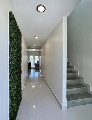 a hallway with stairs and a green wall at Modern Townhouse with terrace! in Homestead