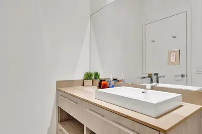 a bathroom with a white sink and a mirror at Oceanfront Condo Direct Ocean & Beach Club Access in Hollywood