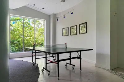 a ping pong table in a room with a window at Ocean View Modern Condo Beach Access 11M in Hollywood