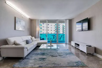 a living room with a couch and a table at Ocean View Modern Condo Beach Access 11M in Hollywood