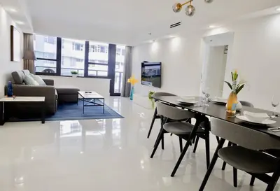 a dining room and living room with a table and chairs at 3 Bedroom Apt Ocean-Front Resort The Alexander in Miami Beach
