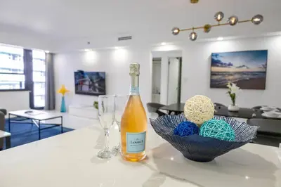 a bottle of wine and a bowl of balls on a table at 3 Bedroom Apt Ocean-Front Resort The Alexander in Miami Beach