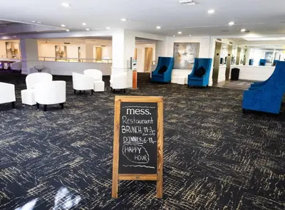 a restaurant with a chalkboard sign in a room at 3 Bedroom Apt Ocean-Front Resort The Alexander in Miami Beach