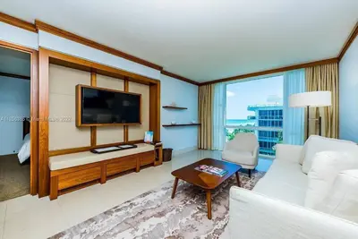 a living room with a white couch and a tv at Ocean View Luxury Carillon Condo at Beach Access C616 in Miami Beach