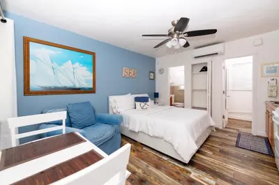 a blue bedroom with a bed and a couch at Tropic Isle Boutique Hotel in Hollywood
