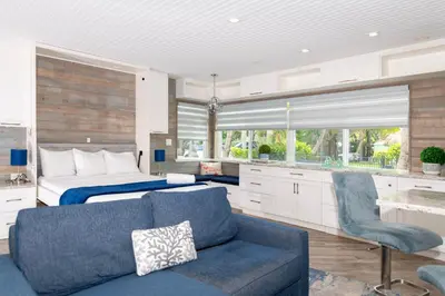 a bedroom with a bed and a blue couch in a room at Tropic Isle Boutique Hotel in Hollywood