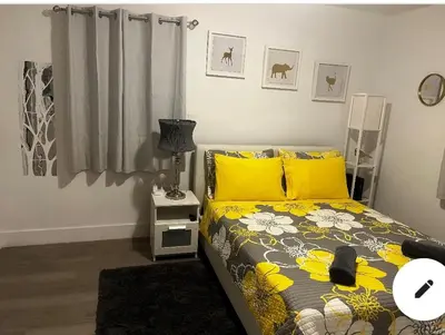a bedroom with a bed with yellow pillows at Home Sweet Home in Miami