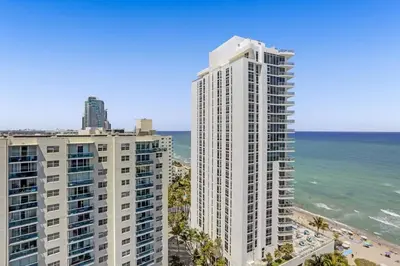 two tall buildings on the beach next to the ocean at Chic 2BDR 2BA Water Front in Hyde Beach in Hollywood