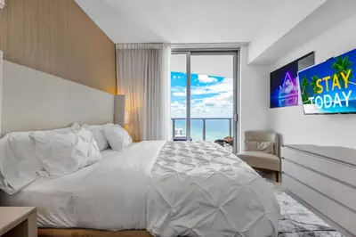 a bedroom with a large bed and a large window at Heaven Resort - 2BDR BEACH HOME WITH OCEAN VIEW HOLLYWOOD! in Hollywood
