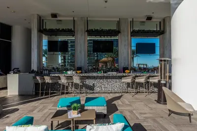 a bar in a hotel with blue chairs and tables at Heaven Resort - 2BDR BEACH HOME WITH OCEAN VIEW HOLLYWOOD! in Hollywood