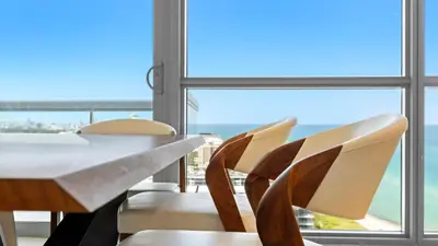 a table and chairs with a view of the ocean at Oceanview Private Penthouse Condo at The Setai -3903 in Miami Beach