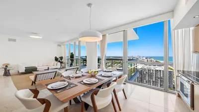 a dining room with a table and views of the ocean at Oceanview Private Penthouse Condo at The Setai -3903 in Miami Beach
