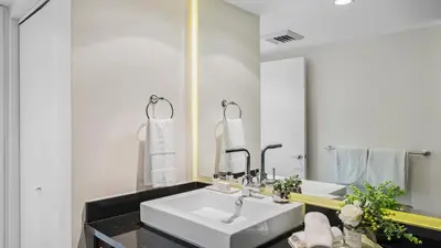 a bathroom with two sinks and a large mirror at Oceanview Private Penthouse Condo at The Setai -3903 in Miami Beach