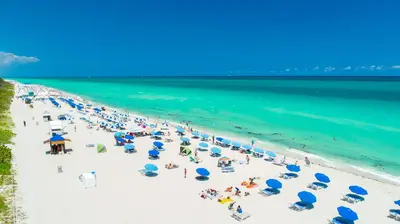 an overhead view of a beach with people and umbrellas at Oceanview Private Penthouse Condo at The Setai -3903 in Miami Beach