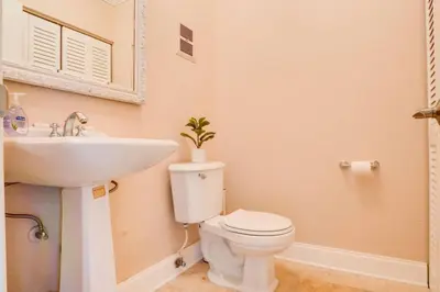 a bathroom with a white toilet and a sink at Intracoastal Oasis in a Prime Area w Pool and BBQ in Fort Lauderdale