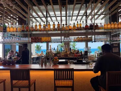 a bar with a view of the ocean and people sitting at it at Direct Oceanfront Condo - Hyde Resort in Hollywood