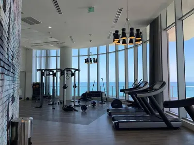 a gym with a view of the ocean in a building at Direct Oceanfront Condo - Hyde Resort in Hollywood