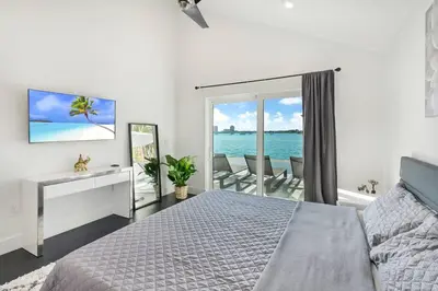 a bedroom with a bed and a view of the ocean at Best Sunset View on the Bay with Pool in Miami Beach