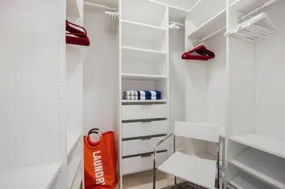a walk in closet with red shoes and an orange bag at Best Bayfront View Heated Pool in Miami Beach