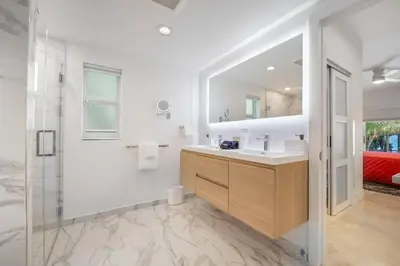a bathroom with a sink and a shower and a mirror at Best Bayfront View Heated Pool in Miami Beach