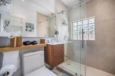 a bathroom with a shower and a toilet and a sink at Best Bayfront View Heated Pool in Miami Beach
