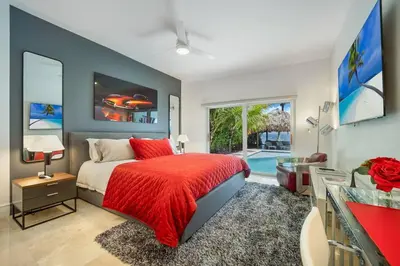 a bedroom with a bed with a red blanket at Best Bayfront View Heated Pool in Miami Beach