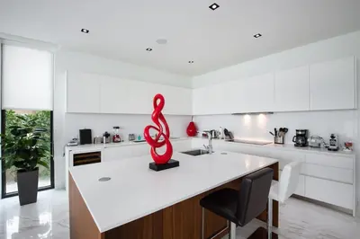 a kitchen with a red sculpture on a counter at Best Sunset Bayfront - pool jacuzzi pool table in Miami Beach