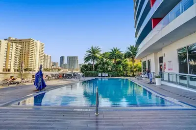 a swimming pool in front of a building at Lovely 3 bedroom 3 bathroom ocean front in Hallandale Beach