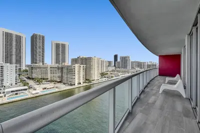 a balcony with a view of the water and buildings at Lovely 3 bedroom 3 bathroom ocean front in Hallandale Beach