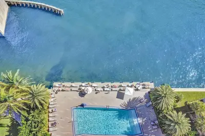 an overhead view of a swimming pool and the ocean at Lovely 3 bedroom 3 bathroom ocean front in Hallandale Beach