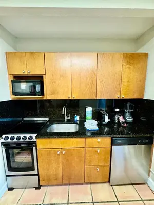 a kitchen with a sink and a microwave at Silver Seas Beach Resort in Fort Lauderdale