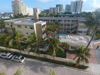 an aerial view of a building with palm trees at Silver Seas Beach Resort in Fort Lauderdale